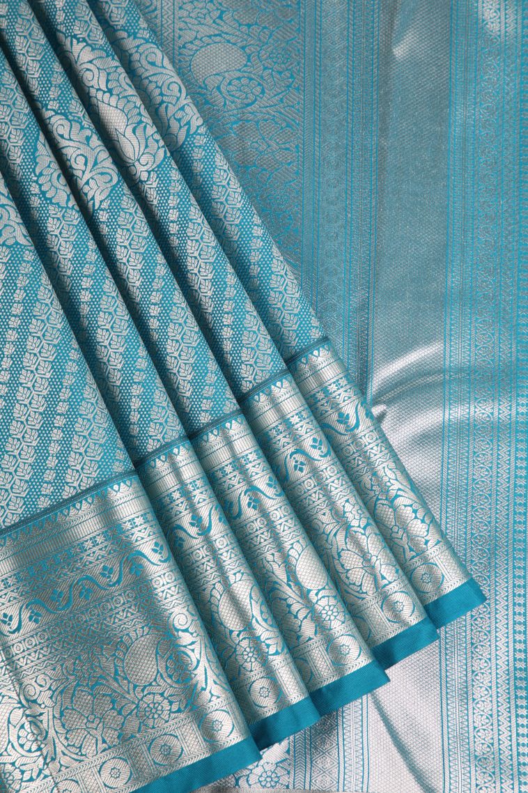 Cerulean Blue Apoorva Silk Sarees with Copper Zari Floral Puttas