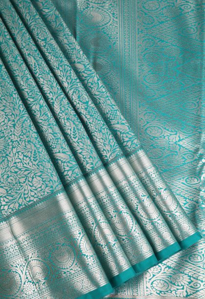 Sapphire Blue Apoorva Silk Sarees with Copper Zari Floral Puttas