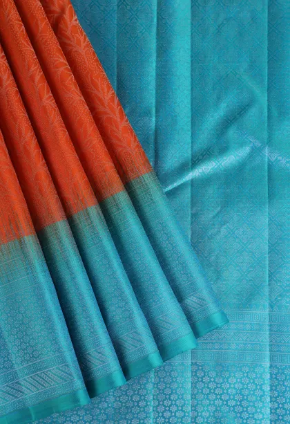 Carrot Orange Soft Silk Saree with Silver Zari Floral Patterns